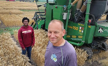 Jochum Wiersma, a University of Minnesota cereal grain specialist, and Roseline “Rose” Kanssole, a research assistant, pose near their research combine during their wheat plot harvest on July 30, 2021, near Fergus Falls Minnesota. Mikkel Pates / Agweek